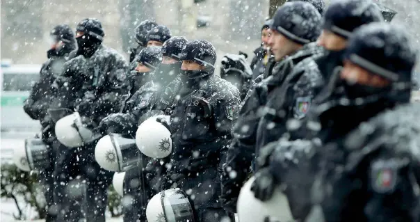  ??  ?? Sotto la neve La polizia in assetto anti sommossa sorveglia una manifestaz­ione durante la Conferenza sulla sicurezza che si è tenuta nel capoluogo bavarese (Michaela Rehle/reuters)