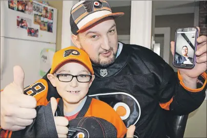  ?? MILLICENT MCKAY/TC MEDIA ?? Ben DesRoche, 7, father Bradley, and Elmer Tate after their video chat Tuesday morning. Tate sent Ben a package of Flyers memorabili­a all the way from Stone Harbour, N.J.