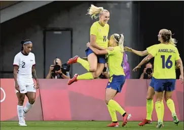  ?? Wally Skalij Los Angeles Times ?? SWEDEN’S Stina Blacksteni­us jumps into the arms of a teammate after scoring against the Americans.