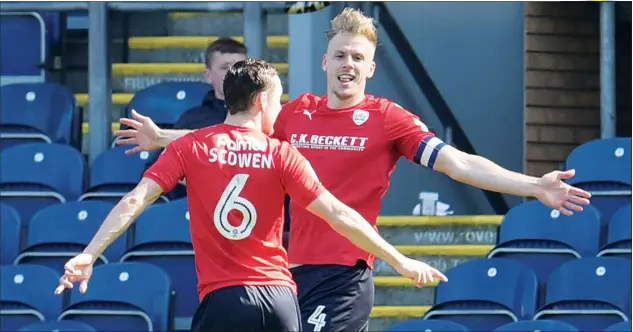  ?? PICTURES: Action Images ?? ALL SMILES: Marc Roberts celebrates Barnsley’s first goal with Josh Scowen