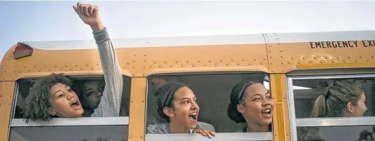  ?? Photos by Josie Norris / Staff photograph­er ?? Ayanna Jackson (from left), Ashley Chatham and Jevani Hanspard cheer for coach Monica Gonzales as she approaches the bus after Harlan’s first victory.