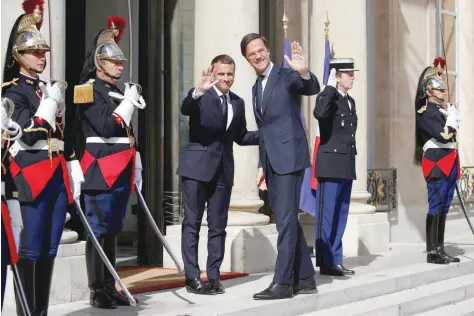  ?? — Reuters ?? French President Emmanuel Macron greets Dutch Prime Minister Mark Rutte before a meeting at the Elysee Palace in Paris, on Friday.
