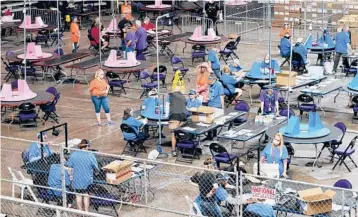  ?? MATT YORK/AP ?? Contractor­s working for Cyber Ninjas examine and recount 2020 Maricopa County ballots May 6 in Phoenix. The review ended Friday without producing proof to support former President Donald Trump’s false claims of a stolen election.