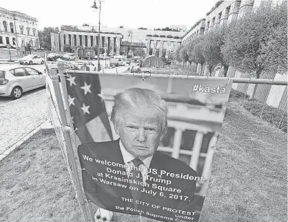  ?? AP ?? A poster is set up in Warsaw on Sunday in advance of President Trump’s visit to Poland on Thursday.