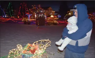  ?? NEWS PHOTO PEGGY REVELL ?? All bundled up, Joey takes Cameron Beers around the Park Meadows annual Christmas lights display Monday evening, as part of the little one’s first Christmas. Once again, Park Meadows residents are inviting the public to come out and enjoy the massive...