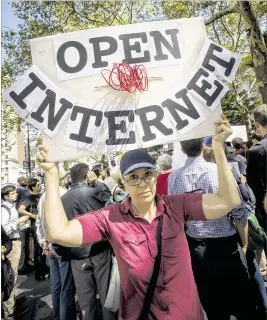  ?? RICHARD B. LEVINE / SIPA USA / TNS ?? Activists protest at City Hall in New York on in 2014 to demand net neutrality protection­s. Millions of comments on the FCC website favored regulation.