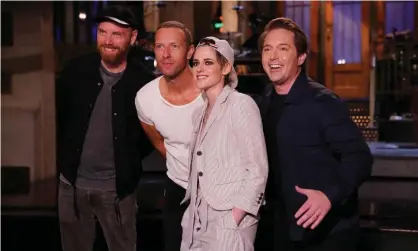  ??  ?? Johnny Buckland and Chris Martin of Coldplay, with host Kristen Stewart and Beck Bennett. Photograph: NBC/NBCU Photo Bank via Getty Images