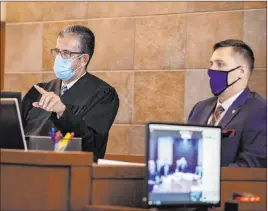  ??  ?? Judge Michael Villani, left, addresses attorneys during a sentencing hearing for Scott Gragson, who received a sentence of eight to 20 years in prison.