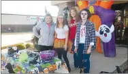  ?? Westside Eagle Observer/SUSAN HOLLAND ?? Ladies from the Grand Savings Bank pose for a photo as they pause from handing out candy to trick or treaters.