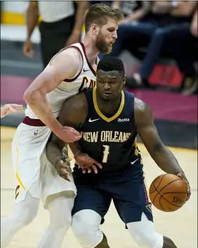  ?? TONY DEJAK — THE ASSOCIATED PRESS ?? The Pelicans’ Zion Williamson drives to the basket against the Cavaliers’ Dean Wade in the second half April 11at Rocket Mortgage FieldHouse.