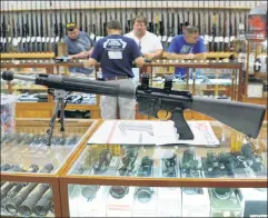  ??  ?? Dangerous tools: A weapons store in Virginia displays rifles that in many other nations would be available only to members of the armed forces.