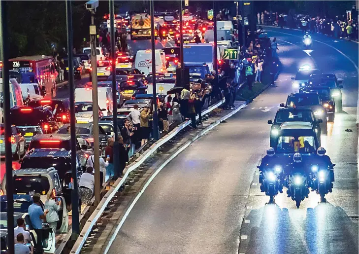  ?? ?? Bumper to bumper: Motorists on the A40 in west London abandoned their cars and lined up on the central reservatio­n to catch a glimpse of the passing procession