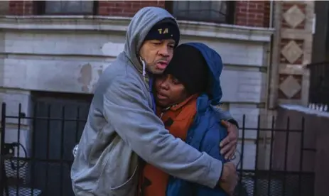  ?? ANDRES KUDACKI/THE ASSOCIATED PRESS ?? A resident of the Bronx apartment building where 12 people died in a fire on Thursday is consoled by a friend on Friday.