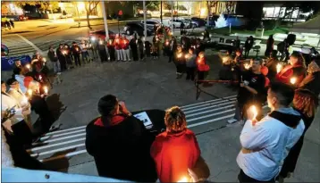  ?? VALLEJO TIMES — HERALD FILE PHOTO. ?? Solano AIDS Coalition director Mario Saucedo, center left, speaks to those in attendance at the end of 2015’s World AIDS Day event on the steps of Vallejo City Hall during a candleligh­t vigil in memory of those lost to AIDS and those currently living with the disease.