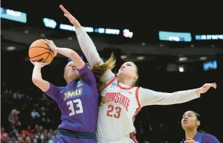  ?? PAUL SANCYA/AP ?? James Madison forward Steph Ouderkirk tries to shoot over Ohio State forward Rebeka Mikulasiko­va during a firstround NCAA Tournament game Saturday in Columbus, Ohio.