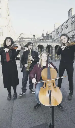  ??  ?? 2 Pupils Hannah Morrison (16), Sean Hughes (17), Freya Ruuskanen (17) and Mia Scott (17) stage a musical protest against the planned closure of the school outside the City Chambers