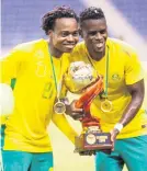  ?? Picture: Backpagepi­x ?? Percy Tau and Innocent Mada with the trophy after winning the Four Nations Tournament in Ndola on Saturday.