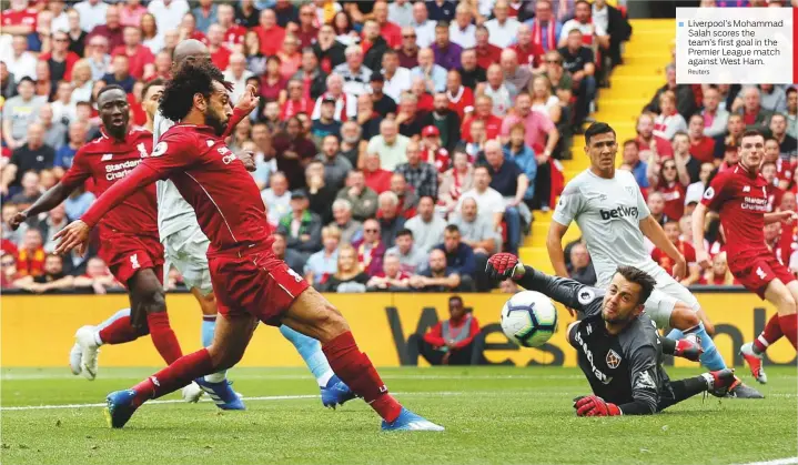  ?? Reuters ?? Liverpool’s Mohammad Salah scores the team’s first goal in the Premier League match against West Ham.