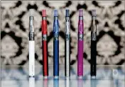  ?? ASSOCIATED PRESS ?? IN THIS APRIL 23, 2014, FILE PHOTO, e-cigarettes appear on display at Vape store in Chicago. Smokers who used e-cigarettes were more likely to kick the habit than those who didn’t, according to a new study that suggests a liberal approach to the...