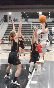  ?? TIMES photograph by Annette Beard ?? Senior Lady Blackhawk Aidan Dayberry jumps for a shot as Lady Lions attempt to block her Tuesday, Feb. 2.