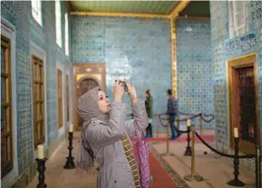  ?? DANIELLE VILLASANA/THE NEW YORK TIMES ?? A woman takes photos in Istanbul’s Hunkar Kasri complex.