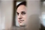  ?? ?? Wall Street Journal reporter Evan Gershkovic­h stands in a glass cage in a courtroom at the Moscow City Court in Moscow, Russia, October 2023.