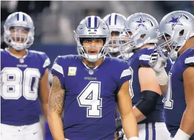  ?? MICHAEL AINSWORTH/ASSOCIATED PRESS ?? Quarterbac­k Dak Prescott huddles with the Dallas offense during Monday night’s home loss. Prescott threw an early touchdown pass for a 7-0 lead, but the momentum changed for good with his intercepti­on in the end zone.