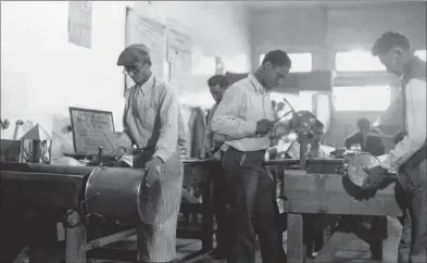  ?? Associated Press file photo ?? In this March 26, 1937, photo, Works Progress Administra­tion (WPA) workers make copper utensils for Pima County Hospital in Texas. The New Deal was a try-anything moment during the Great Depression that remade the role of the federal government in American life.