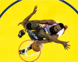  ?? (Reuters) ?? HOUSTON ROCKETS guard James Harden (right) dunks on Golden State Warriors defender Draymond Green for two of his game-high 30 points in the Rockets’ 95-92 road victory on Tuesday night to even the Western Conference finals at two games apiece.