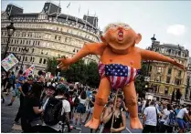  ?? RATCLIFFE / GETTY IMAGES CHRIS J ?? Protesters take part in a demonstrat­ion against President Trump’s visit to the UK in Trafalgar Square on Friday in London. Tens of thousands of anti-Trump protesters demonstrat­ed in London and across the country.