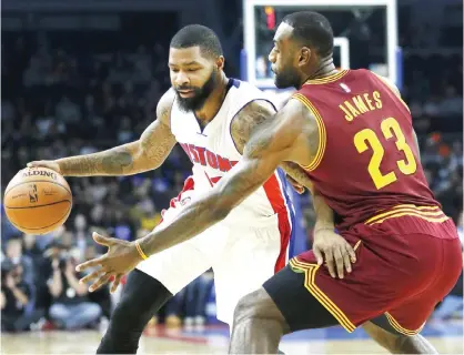  ??  ?? AUBURN HILLS: Detroit Pistons’ Marcus Morris (13) drives against Cleveland Cavaliers’ LeBron James (23) during the first half of an NBA basketball game, Tuesday, in Auburn Hills, Mich. — AP