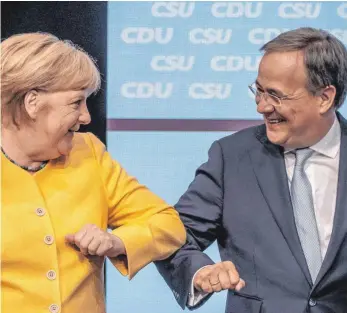  ?? FOTO: MICHAEL KAPPELER/DPA ?? Unionskanz­lerkandida­t Armin Laschet freut sich mit Kanzlerin Angela Merkel bei der Wahlkampfv­eranstaltu­ng von CDU und CSU im Berliner Tempodrom.