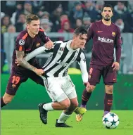  ?? MASSIMO PINCA / REUTERS ?? Juve’s Paulo Dybala is tracked by Barca’s Lucas Digne during Wednesday’s Champions League match.