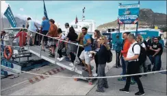  ?? PHOTO: EPA ?? Tourists board a sight-seeing boat at the tour boat wharf in Hout Bay harbour, Cape Town. The writer says that tourism is on the rise both in South Africa and across the whole of Africa.