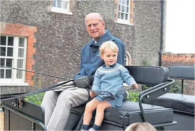  ??  ?? Prince Philip with Prince George in his horse-drawn carriage. Picture courtesy of The Duchess of Cambridge.