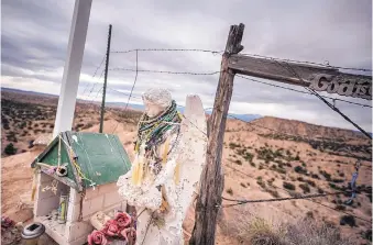  ?? ROBERTO E. ROSALES/JOURNAL ?? ABOVE: An angel draped in rosaries atop a hill south of Chimayó beside N.M. 503. Pilgrims en route to the Santuario de Chimayó have made a makeshift shrine here.