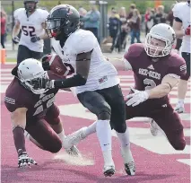  ?? MATTHEW USHERWOOD/FILES ?? Carleton Ravens Tunde Adeleke dodges Ottawa Gee-Gees players en route to scoring a 129-yard touchdown during the 2013 Panda Game. The Ravens have won the past two annual classics.