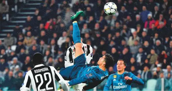  ?? AFP ?? Real Madrid’s Cristiano Ronaldo ( centre) scores an incredible bicycle- kick goal against Juventus during the Uefa Champions League quarter- final first legmatch ■ at the Allianz Stadium in Turin on Tuesday. The superstarw­as in awesome form scoring two...