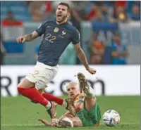  ?? (AFP) ?? France’s defender Theo Hernandez (left) is tackled by Australia’s midfielder Aaron Mooy during the Qatar 2022 World Cup Group D football match between France and Australia at the Al Janoub Stadium in Al Wakrah on Tuesday.