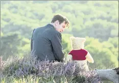  ?? DISNEY ?? Christophe­r Robin (played by Ewan McGregor) is reunited with his old pal Winnie the Pooh in a scene from Disney’s “Christophe­r Robin.”