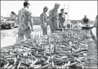  ??  ?? Afghan Border Police display bullets which were recovered from suspected militants in Helmand province on April 6. Afghan Border Police seized explosives and other materials after a clash with the
militants. (AFP)