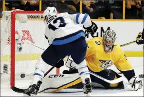  ?? AP/MARK HUMPHREY ?? Winnipeg Jets left wing Brandon Tanev scores a goal against Nashville Predators goalie Pekka Rinne during the first period of Game 1 of Friday’s second-round playoff series in Nashville, Tenn. The Jets won 4-1.