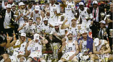  ?? FOTO: EFE ?? Los jugadores del Real Madrid posan sobre el parquet tras recibir el trofeo de campeones 2023