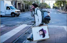  ?? RAY CHAVEZ — STAFF PHOTOGRAPH­ER ?? San Francisco homeless artist Daniel McClenon heads to his painting location outside Westfield San Francisco Centre on Market Street in May.