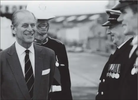  ?? Picture: The News ?? SERVICE Mr Archie Weston of the Royal Naval Volunteer Band of HMS Collingwoo­d shares a joke with Prince Philip, the Duke of Edinburgh in December 1993