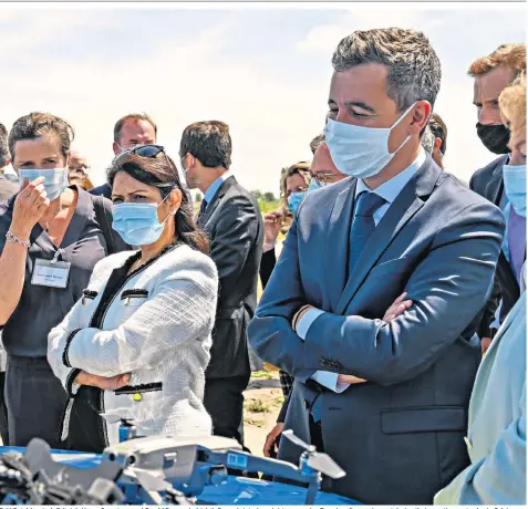  ??  ?? Priti Patel (centre), Britain’s Home Secretary, and Gerald Darmanin (right), France’s interior minister, examine French police equipment during their meeting yesterday in Calais