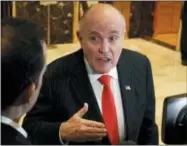  ?? EVAN VUCCI — THE ASSOCIATED PRESS FILE ?? Former New York City Mayor Rudy Giuliani talks with reporters in the lobby of Trump Tower in New York.