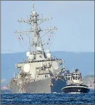  ?? AP/EUGENE HOSHIKO ?? A tugboat pulls the damaged USS Fitzgerald to its home port of Yokosuka Naval Base south of Tokyo on Saturday. The destroyer’s collision with a cargo ship caused flooding in berthing areas as most of its crew slept.