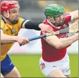  ?? (Pic: George Hatchell) ?? Cork’s Seamus Harnedy evades from the challenge of Clare’s John Conlon in the Allianz Hurling League tie at Cusack Park; Ennis.