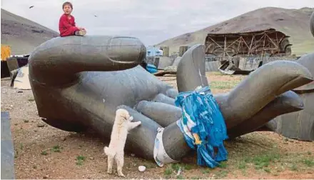  ?? AFP PIC ?? A boy playing at the constructi­on site of the Grand Maitreya Spiritual Centre on the outskirts of Ulan Bator in June.